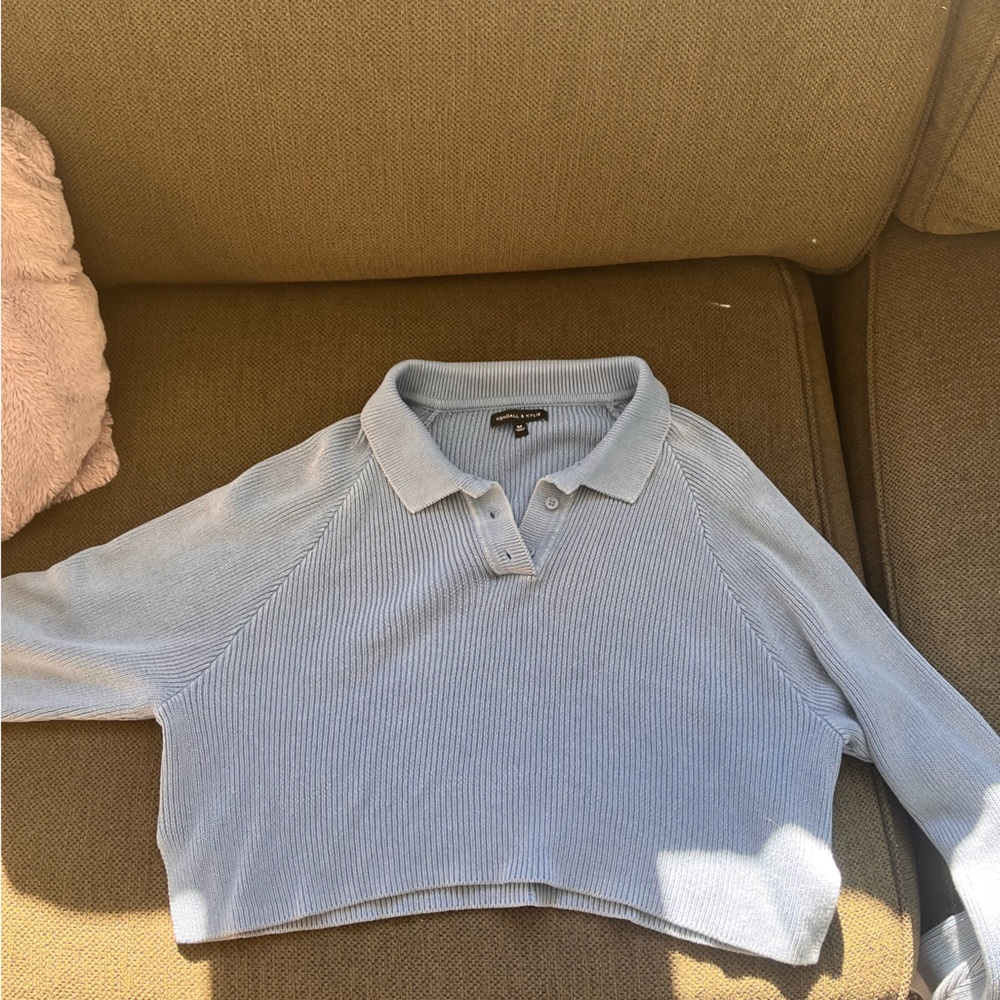 light blue, cropped, kendall and kylie sweater, about an inch cut on the sides!